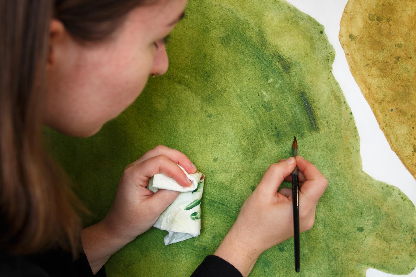 Der Künstlerin Anja Dommel beim Malen einer Reiseerinnerung aus Nordirland über die Schulter schauen